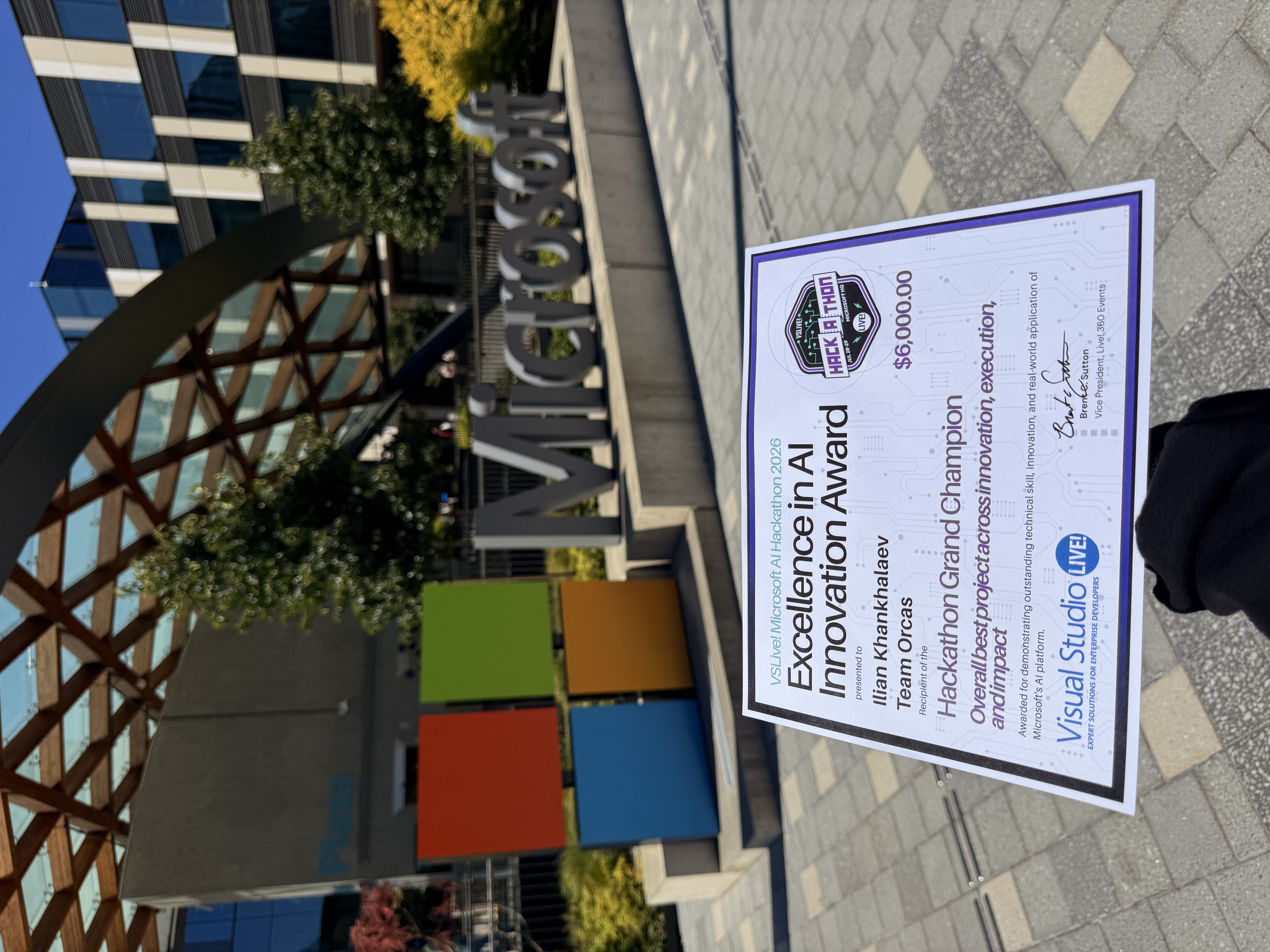 Excellence in AI Innovation Award certificate held in front of the Microsoft sign at Microsoft headquarters in Redmond